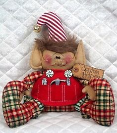 a stuffed animal with a red dress and hat