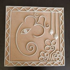 an intricately designed tile with the letter e on it