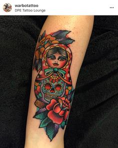 a woman's arm with a tattoo on it and a skull in the middle