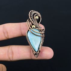 Handmade Copper Chain Size 18-20Inch - https://www.etsy.com/in-en/listing/1162990726 Welcome to our little shop, where you can find handmade copper wire jewelry and more, for you and your loved ones. We do accept custom orders also, kindly message us for more. Larimar Gemstone Copper Wire Wrapped Handmade Pendant Gemstone : Larimar  Pendant length : 7 Cm Metal : Copper  * Protection:- Copper will be tarnished after a while so try to limit contact with lotions, soaps or anything moist and never wear it in the shower, swimming or anywhere else it may come in contact with water. If tarnish becomes an issue, you may clean this item with jewelry cleaning cloth or ultra polishing pads. * Packing:- Your jewelry arrived in a beautiful gift box stored in bubble wrap for safe travel. * Rush your ord