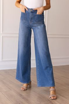 Elevate your denim game with our Medium Wash Wide Leg Flare featuring front pockets for a touch of functionality and style. Crafted from high-quality denim, these wide-leg jeans offer a flattering silhouette with a nod to retro vibes. Perfect for a casual day out or a stylish night on the town, these jeans effortlessly combine comfort and fashion-forward flair.Material & Features: Material: 70% Cotton 18% Polyester 10% Viscose 2% Spandex Stretch: Yes Zipper Fly Front and Back Patch Pockets How i Oasis Clothing, Americana Fashion, Top Graphic Tees, Curves Workout, Sleeveless Sweater, Colored Denim, Retro Vibe, Matilda, Kids Bottoms