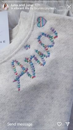 a sweater with the word hope embroidered on it and a card in front of it