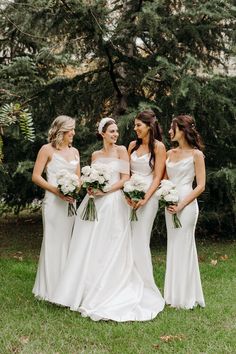 the bridesmaids are all dressed in white dresses