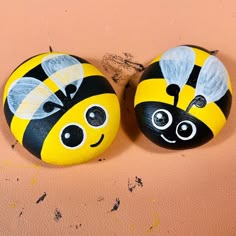 two painted rocks that look like bees