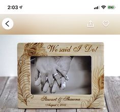 a wooden photo frame with two hands and the words we and i do on it