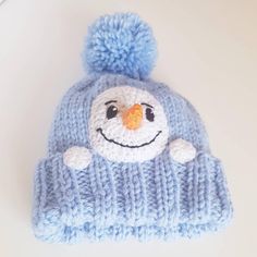 a knitted hat with a smiling face on it