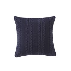 a dark blue cable knit pillow on a white background