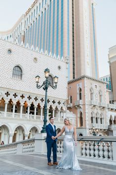 a bride and groom hold hands in front of the venetian garden hotel, las vegas