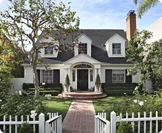 a white house with black shutters on the front