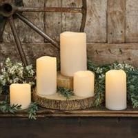 white candles are arranged on a wooden stand