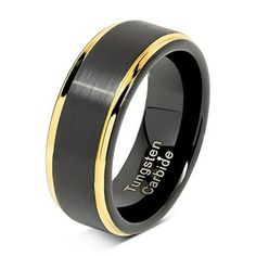 men's black and gold wedding band with an inscription on the inside of it