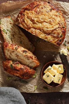 bread, cheese and butter are sitting on wax paper