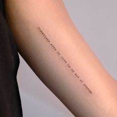 a woman's arm with a quote on it