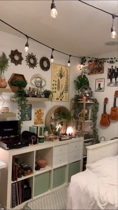 a bed room with a neatly made bed and lots of plants on the wall above it