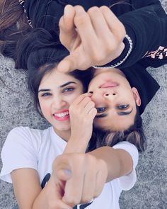 two girls with their faces painted to look like they are pointing at the camera