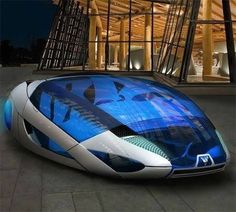 a futuristic car parked in front of a building