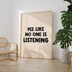 there is a poster with the words pee like no one is listening on it next to a chair and potted plant