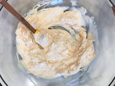 a bowl filled with batter and two wooden spoons