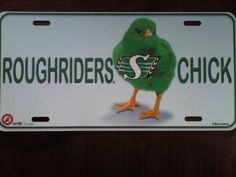 a green bird with the letter s on it's back is standing in front of a white license plate