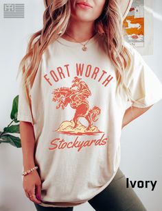 "PRODUCTION TIME: 1-3 days (Usually 2 days) SHIPPING TIME: 2-5 days (Usually 3 days) 👕PRODUCT DESCRIPTION👕  Step back in time with our \"Experience Fort Worth Stockyards\" t-shirt, where the spirit of the Old West comes to life. This vintage-inspired tee showcases a rugged rodeo cowboy astride a majestic horse, capturing the essence of the iconic Fort Worth Stockyards. Embrace the Texan charm with this Texas tee that pays homage to the rich history of Fort Worth. Crafted on a unisex comfort co White Soft-washed Fan Apparel Top, White Soft-washed T-shirt For Fan Merchandise, Fort Worth Photoshoot, Stockyards Fort Worth, Fort Worth Stockyards Photography, The Stockyards Fort Worth, Fort Worth Stockyards, Century Hall Fort Worth, Rodeo Cowboy