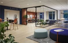 a living room filled with furniture and lots of windows next to a dining room table