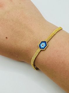 - Handmade beaded blue evil minimalist protection bracelet - Miyuki seed beads, gold beads are 24K gold plated - The length of bracelet is 17 cm (6.7 inches) extended 5 cm (2 inches), bracelet width 0.4 cm (1.6 inches) JEWELRY CARE - Keep jewelry dry - Take it off before taking shower, bath, swimming or exercising - Makeup, perfume, hairspray apply before wearing jewelry - Store your jewelry somewhere dry, not in the bathroom Handmade in Cyprus PACKING All items are sent in a presentable gift bo Protection Bracelet, Gold Plated Bracelets, Keep Jewelry, Blue Bracelet, Gold Beads, Handmade Bracelets, Jewelry Care, Arm Band, Jewelry Stores