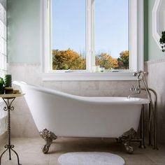 a white bath tub sitting next to a window