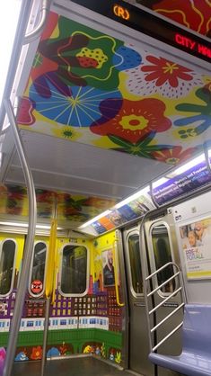 the interior of a subway car with colorful decorations