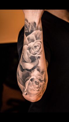 a man's arm with roses on it