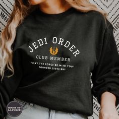 a woman wearing a black shirt that says jedi order club member