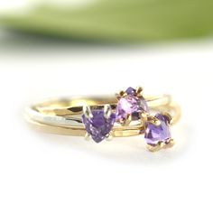 Trillion Cut Amethyst Solitaire Ring A trillion cut sparkling purple amethyst prong set in 14k gold-fill with skinny hammered band. So perfectly dainty and great for stacking. Amethyst is the February Birthstone. This style ring available in a variety of natural gemstones including: Garnet (January) Amethyst (February) Aquamarine (March) White Topaz (April) Emerald* (May) Alexandrite* (June) Ruby* (July) Peridot (August) Blue Sapphire* (September) Pink Sapphire (September) Opal (October) Pink To Dainty Stackable Amethyst Ring For Anniversary, Stackable Amethyst Birthstone Ring For Anniversary, Stackable Amethyst Birthstone Promise Ring, 14k Gold Stackable Amethyst Promise Ring, October Pink, February Birthstone Ring, Gemstone Stacking Ring, Hammered Band, Blue Tourmaline