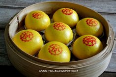 six oranges in a wooden basket with red writing on the top and yellow inside