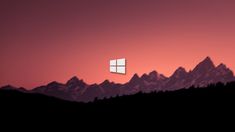 an image of a window in the middle of mountains at sunset or sunrise with red sky