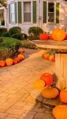 pumpkins on the ground in front of a house