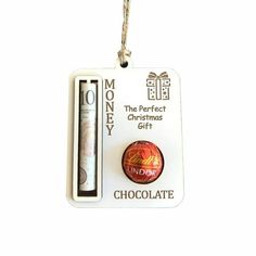 a christmas ornament with a chocolate bar in the middle and a gift tag attached to it