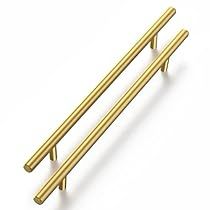 two gold colored metal handles on a white background