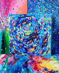 an abstract painting with bright colors and sprinkles on the canvas, as well as