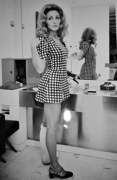 a woman standing in front of a kitchen sink