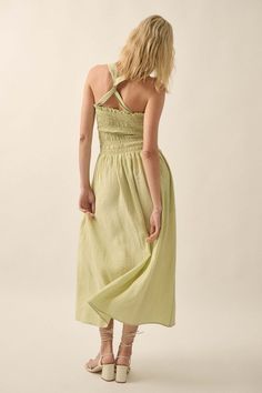 Textured tonal-stripe midi dress. Square neckline. Smocked bodice with ruffle. Sleeveless with wide shoulder straps. Side pockets. Low back with crisscross straps. Fit-and-flare silhouette. 85% Rayon, 15% Nylon. Imported. Designed in LA. Model wears size S. Green Sundress With Smocked Back, Vacation Smocked Midi Dress With Tie Straps, Vacation Midi Smocked Dress With Tie Straps, Summer Midi Dress With Ruched Ruffled Straps, Summer Midi Dress With Ruched And Ruffled Straps, Casual Midi Dress With Smocked Back And Ruffled Straps, Spring Smocked Midi Dress With Tie Straps, Sundress With Smocked Back Midi Length, Midi Sundress With Smocked Back