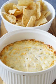 two white bowls filled with dip and chips