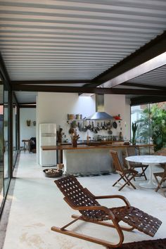 an outdoor kitchen and dining area with sliding glass doors