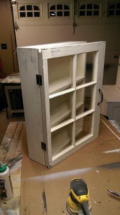 an old cabinet is being worked on with tools