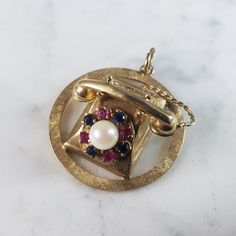 A Womens Vintage Estate 14k Yellow Gold Rubies And Sapphire Telephone Brooch. Not Sure If The Stones Are Natural Or Man Made. The Brooch Measures 1 1/2" Long By 1 1/4" Wide, And Weighs 12.2g. Would Make A Great Gift For That Special Someone. Any Questions Please Do Not Hesitate To Ask. Be Sure To Check Out Some Of My Other Great Items Up For Sale. Thank You. Gold Multi-stone Fine Jewelry Brooches, Fine Jewelry Gold Brooches With Multi-stone, Vintage Multi-stone Yellow Gold Brooches, Vintage Yellow Gold Multi-stone Brooches, Fine Jewelry Multi-stone Yellow Gold Brooches, Fine Jewelry Yellow Gold Multi-stone Brooches, Yellow Gold Multi-stone Brooches As Gift, Formal Yellow Gold Multi-stone Brooches, Gold Multi-stone Brooch For Formal Occasions