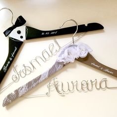 two wedding clothes hangers with the word bride and groom written on them