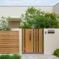 a wooden gate is in front of a house