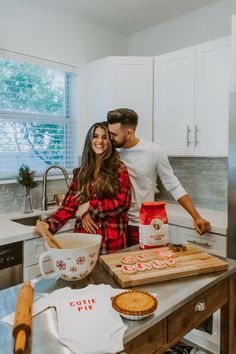 a man and woman are standing in the kitchen preparing pies for christmas morning breakfast