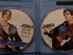 two dvd discs with the same image on them, one has a man holding a guitar