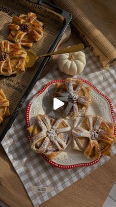 several pastries are on a plate next to some pumpkins