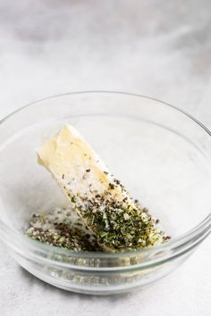 a glass bowl filled with food on top of a table