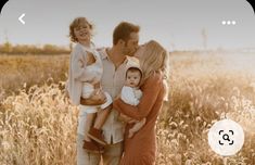 a man and woman holding two children in a field with the number 3 on it